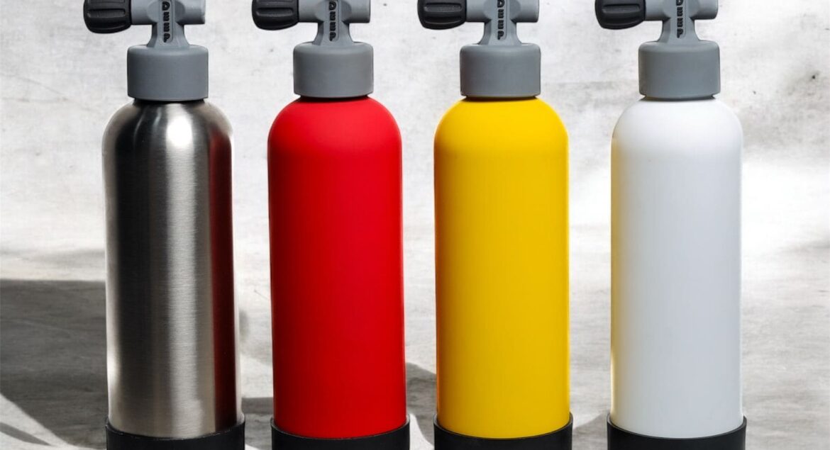 Four Deep stainless steel water bottles in red, silver, yellow, and white, designed for scuba divers and ocean lovers.